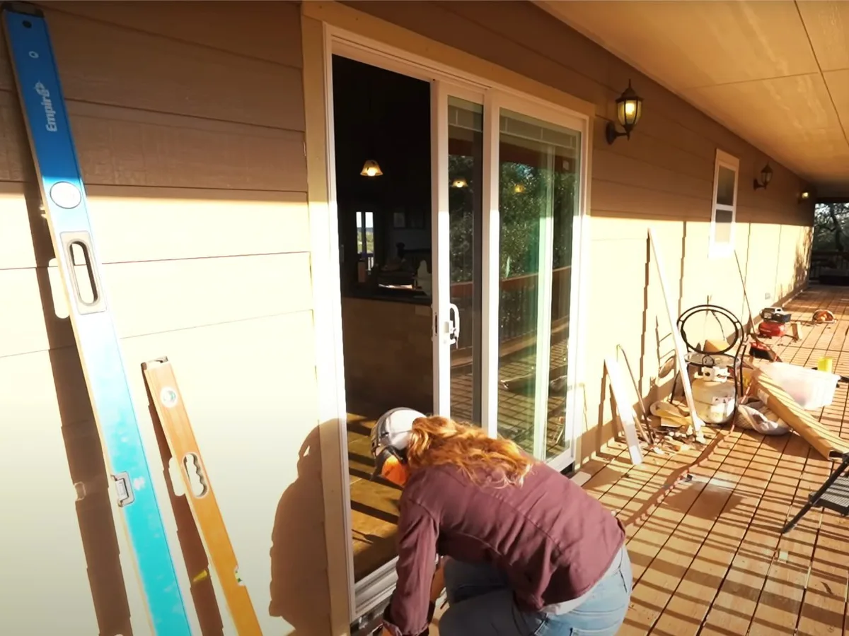 Technician working beside a sliding patio door
