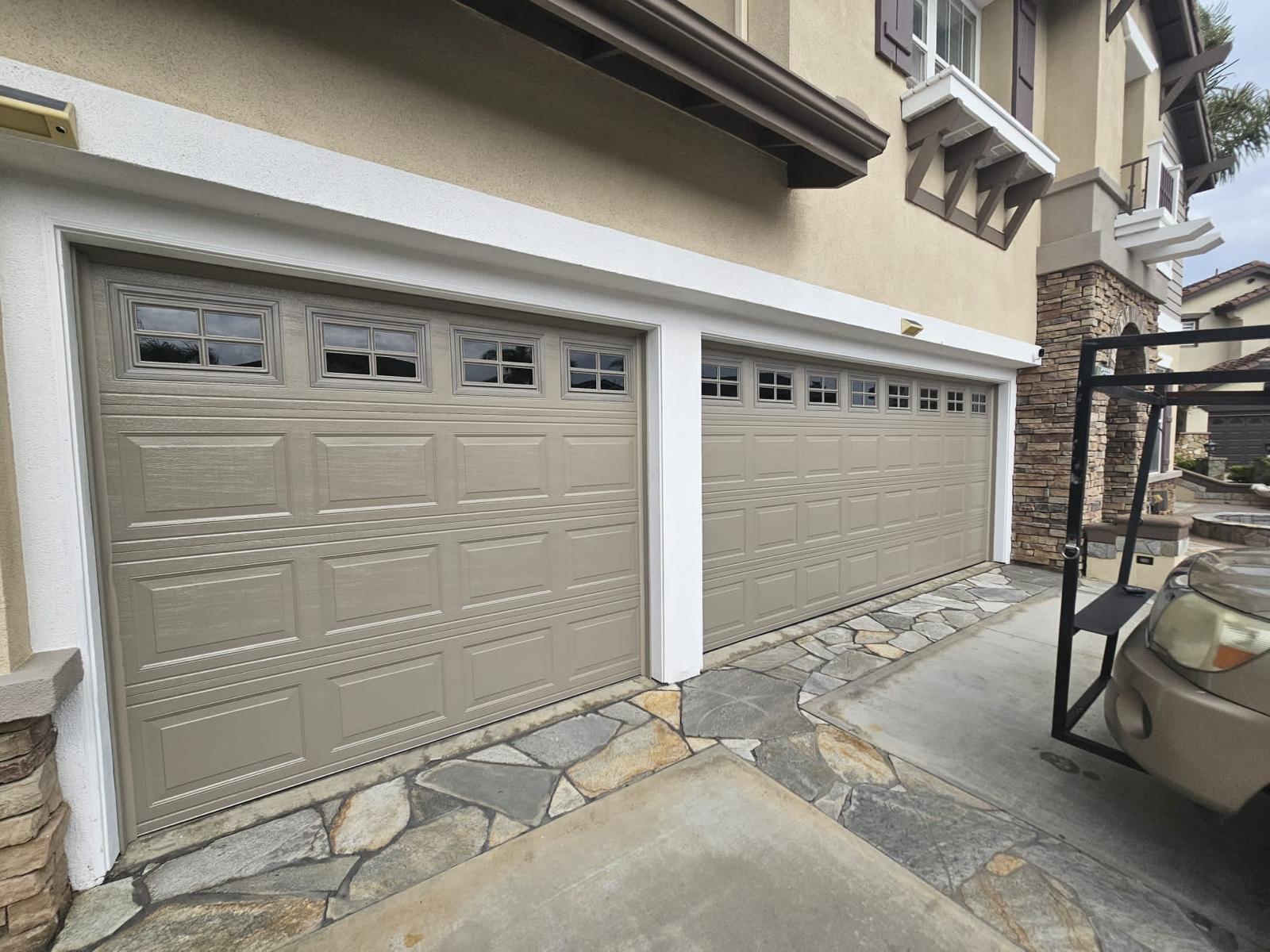 Tan carriage garage doors installed on luxury home Long Beach CA